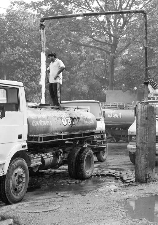 Tankers being filled to supply drinking water in informal colonies in South-West District, National Capital Territory of Delhi